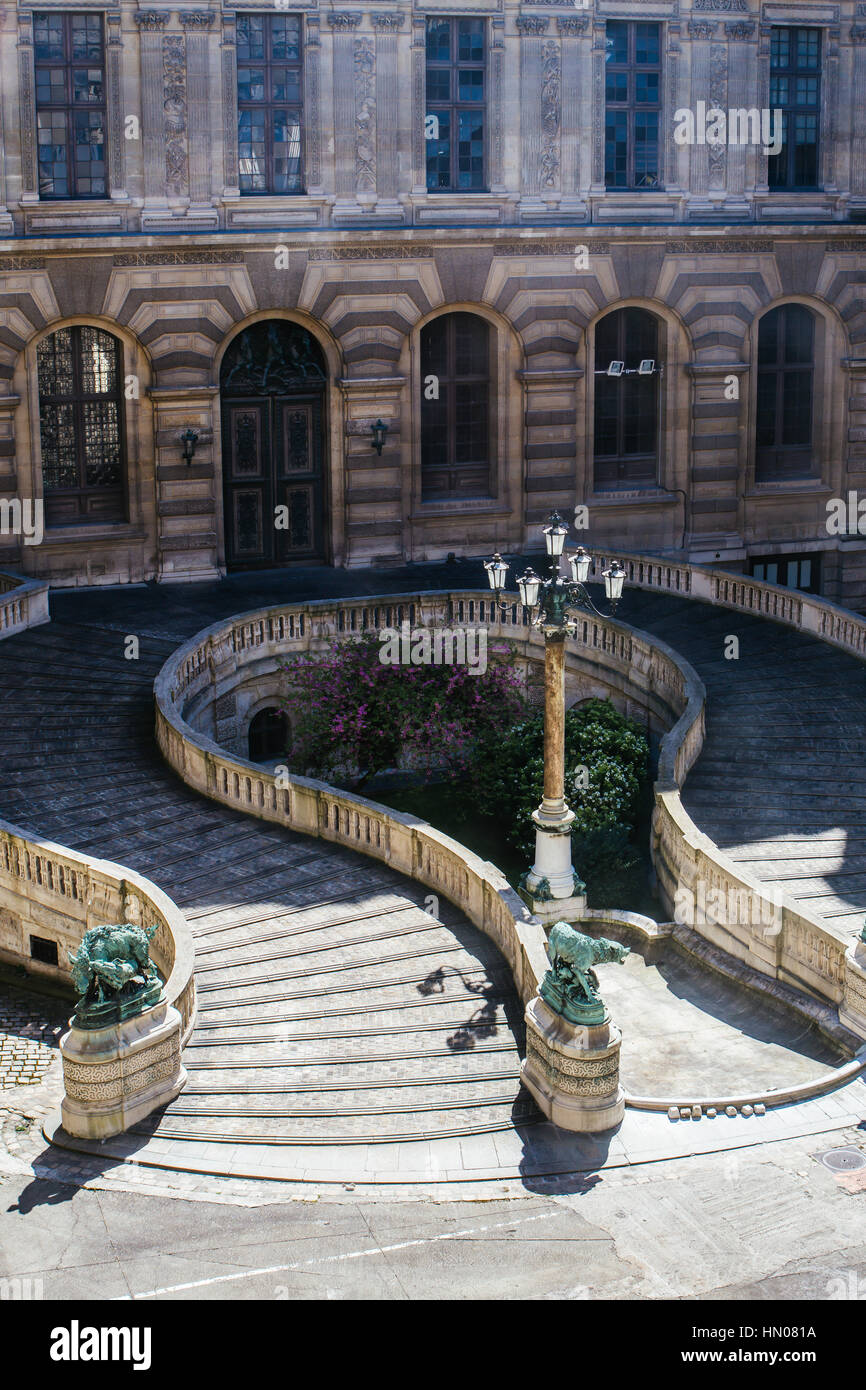 Steps of a yard at the Louvre palace with a lantern in the middle Stock Photo