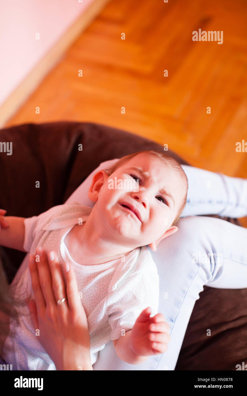 Mom makes the baby massage Stock Photo - Alamy