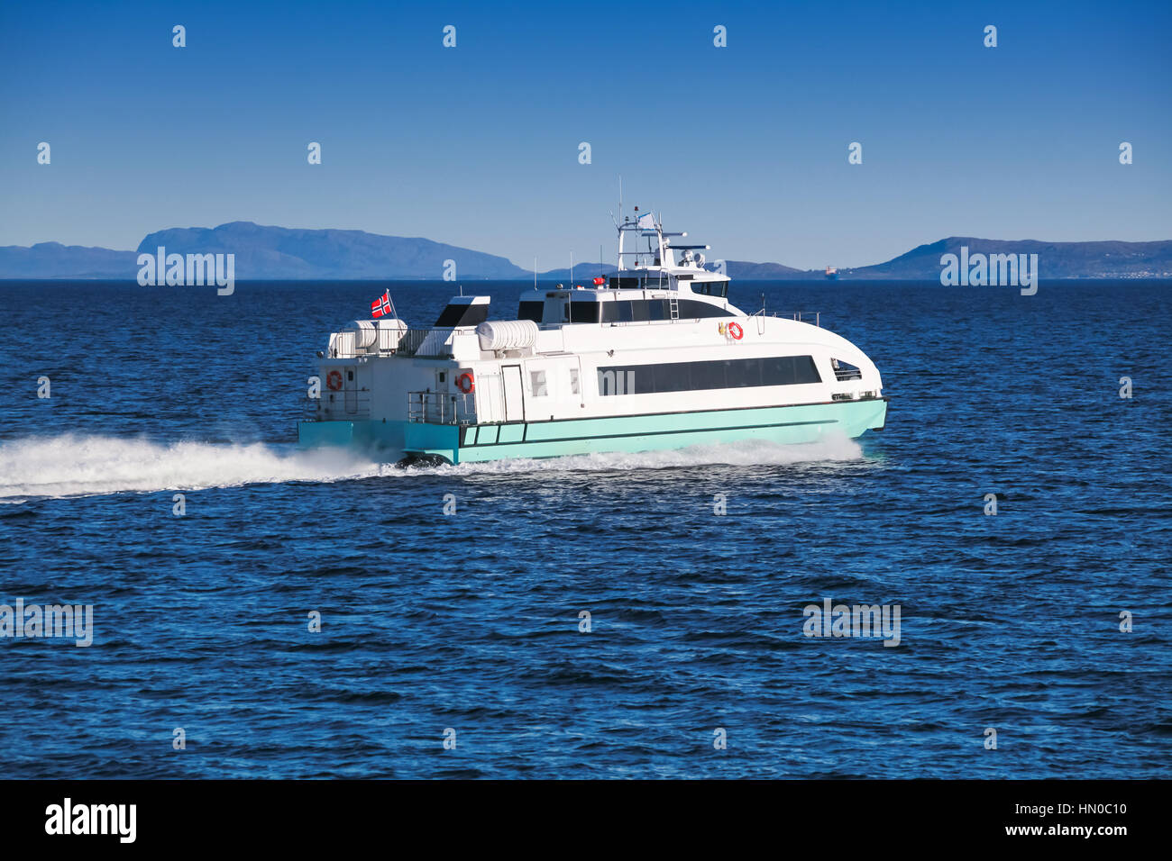 Fast passenger ferry boat goes on Norwegian sea. Trondheim, Norway Stock Photo