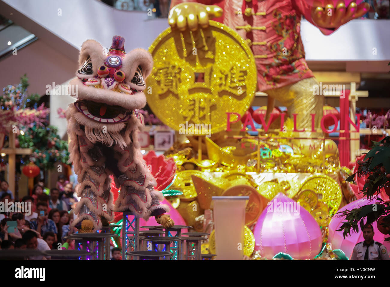 Lion dance performance on high pole at Pavillion shopping gallery