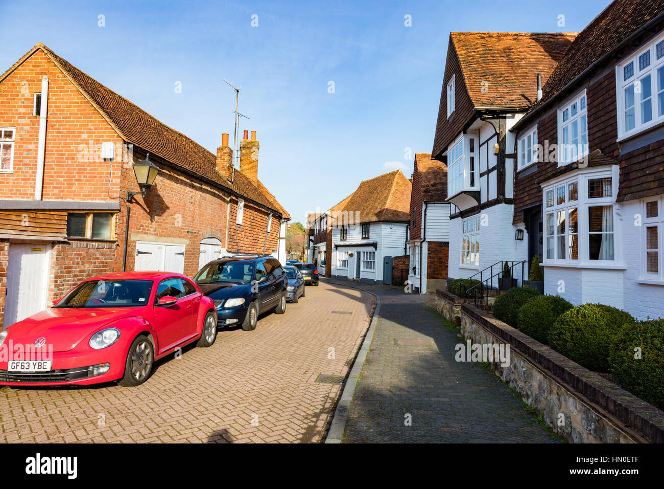 Cottages and cars parked in the village of Hadlow, Church Street, Kent, UK Stock Photo