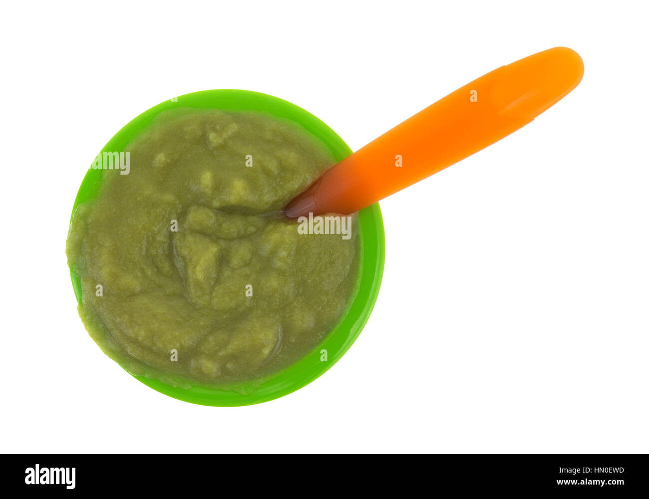Top view of a serving of green peas baby food in a small bowl with an