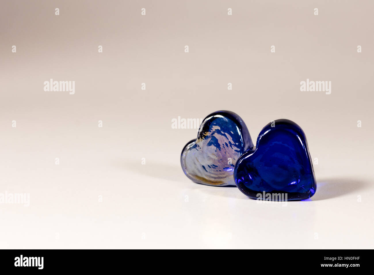 Two blue glass hearts (still life) on white background Stock Photo