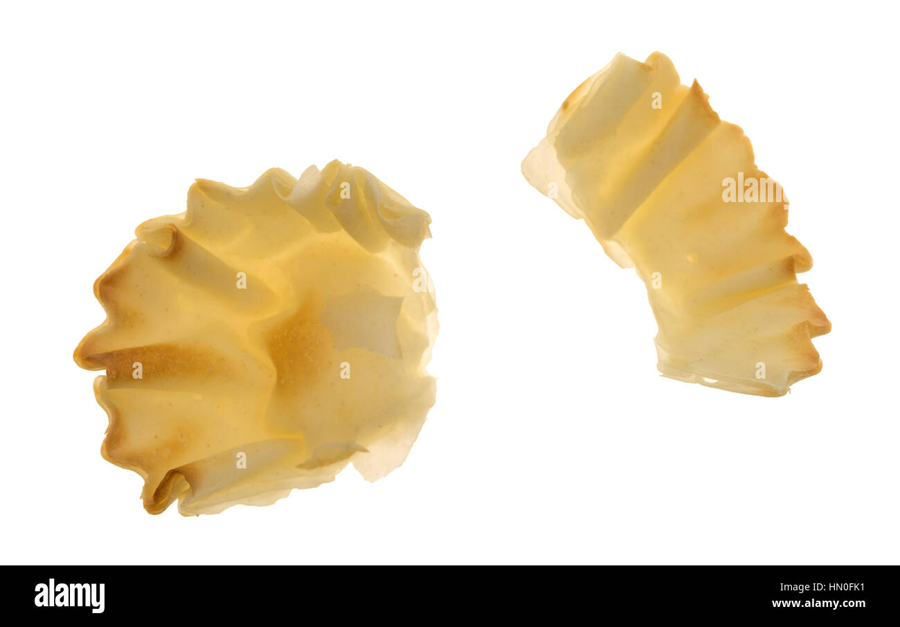 A broken miniature phyllo shell broken isolated on a white background ...