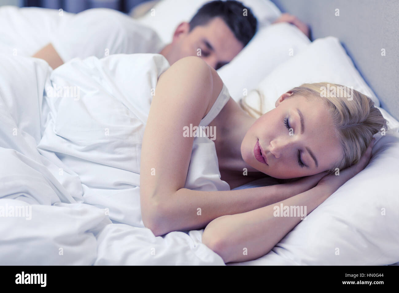 happy couple sleeping in bed Stock Photo - Alamy