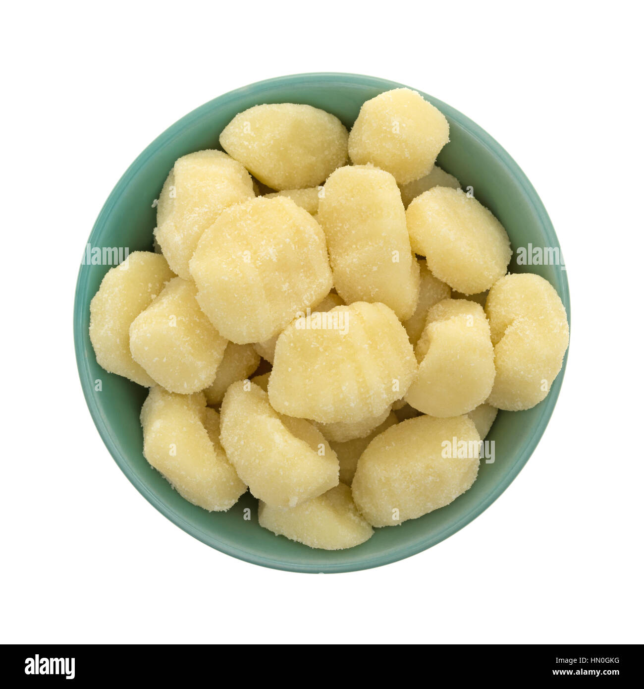 Top view of plain potato gnocchi in a green bowl isolated on a white background. Stock Photo