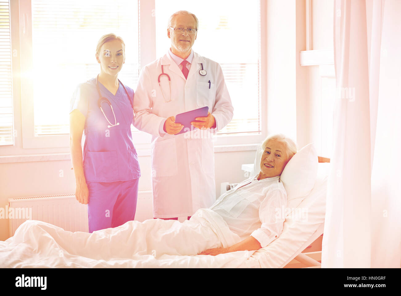 doctor and nurse visiting senior woman at hospital Stock Photo - Alamy