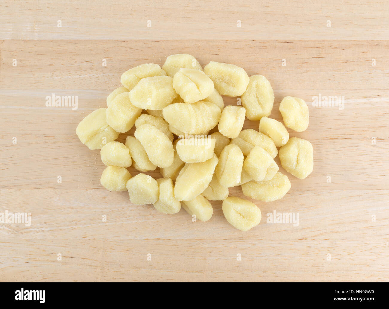 Top view of a portion of plain potato gnocchi on a wood counter top. Stock Photo