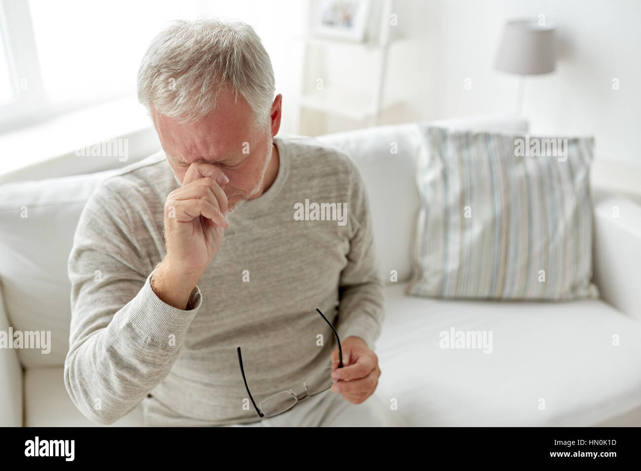 senior man suffering from headache at home Stock Photo - Alamy