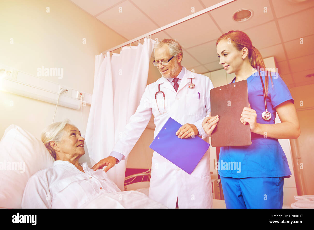 doctor and nurse visiting senior woman at hospital Stock Photo - Alamy