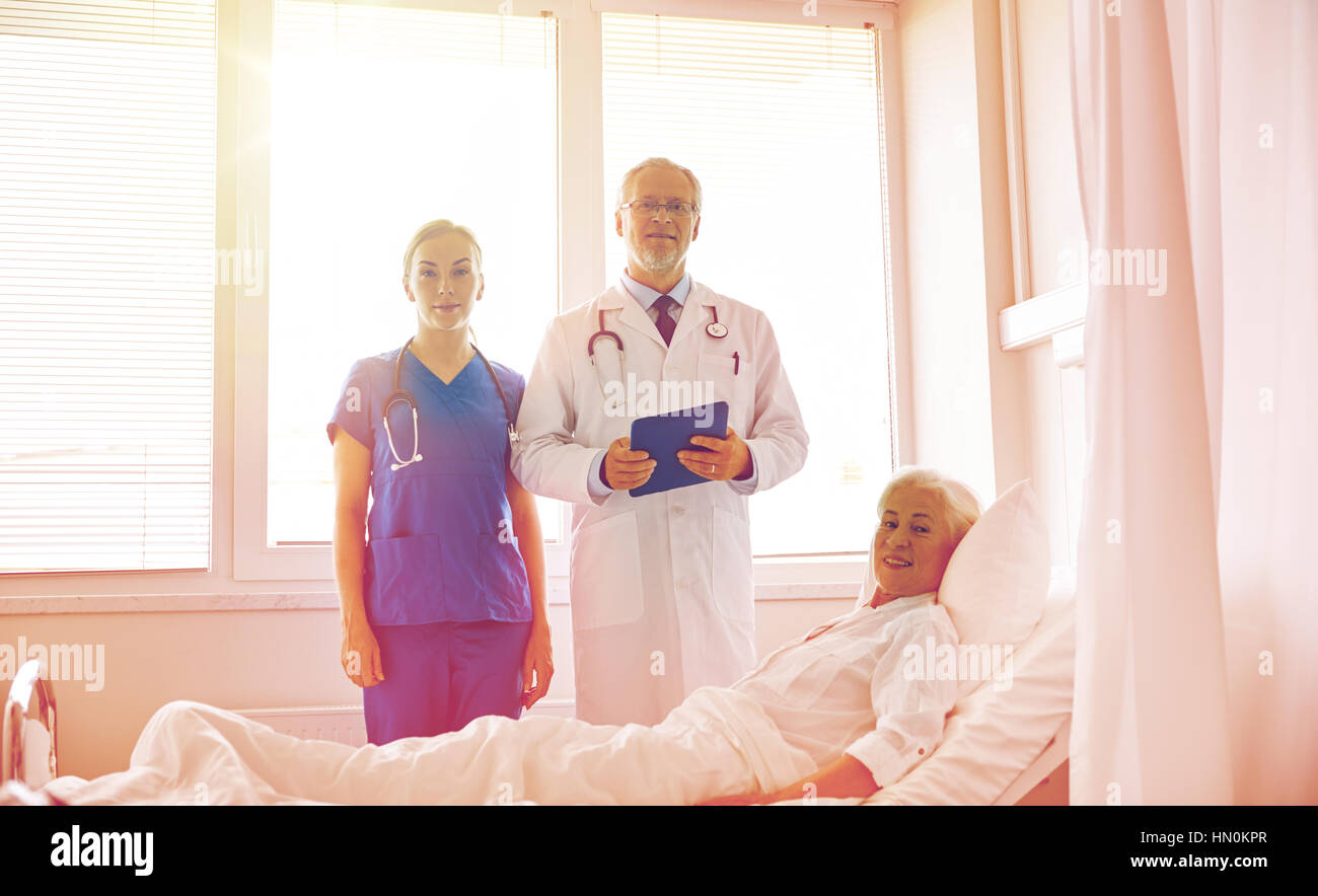 doctor and nurse visiting senior woman at hospital Stock Photo - Alamy