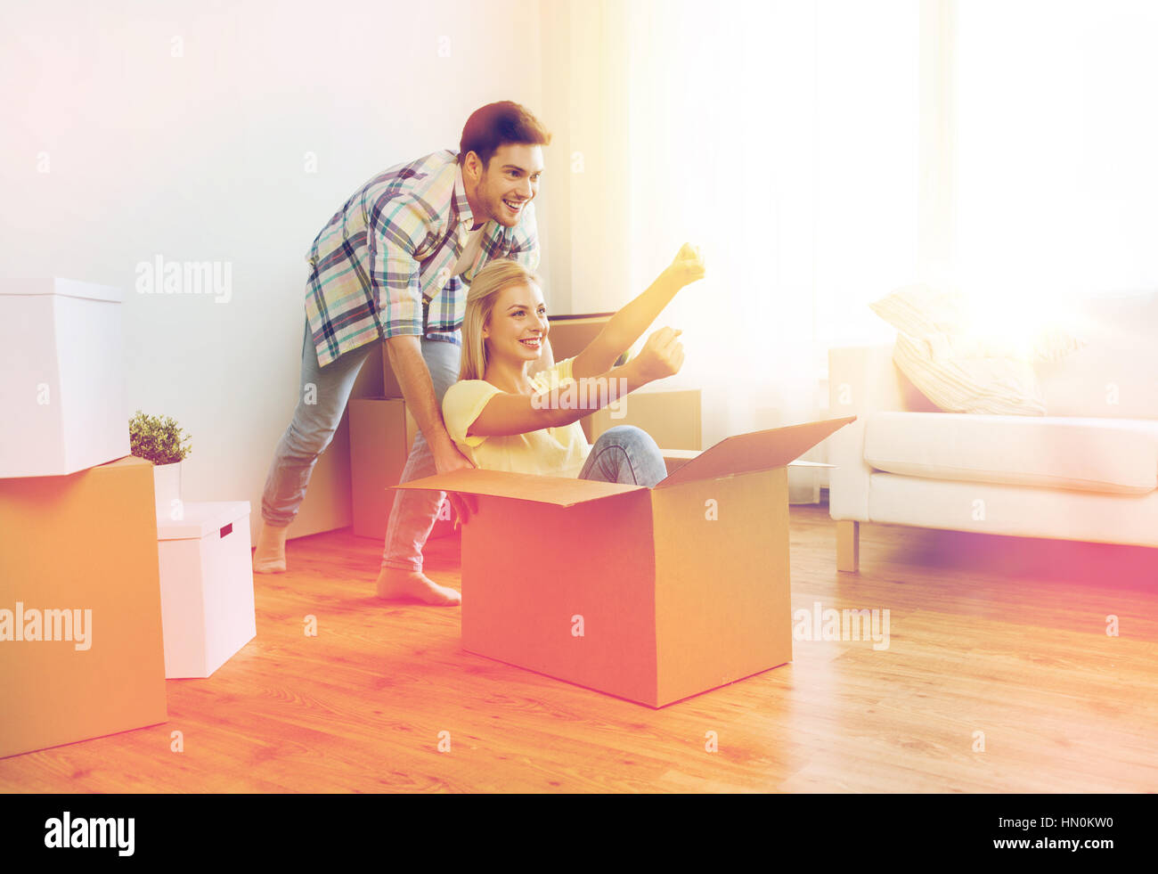 happy couple having fun with boxes at new home Stock Photo - Alamy
