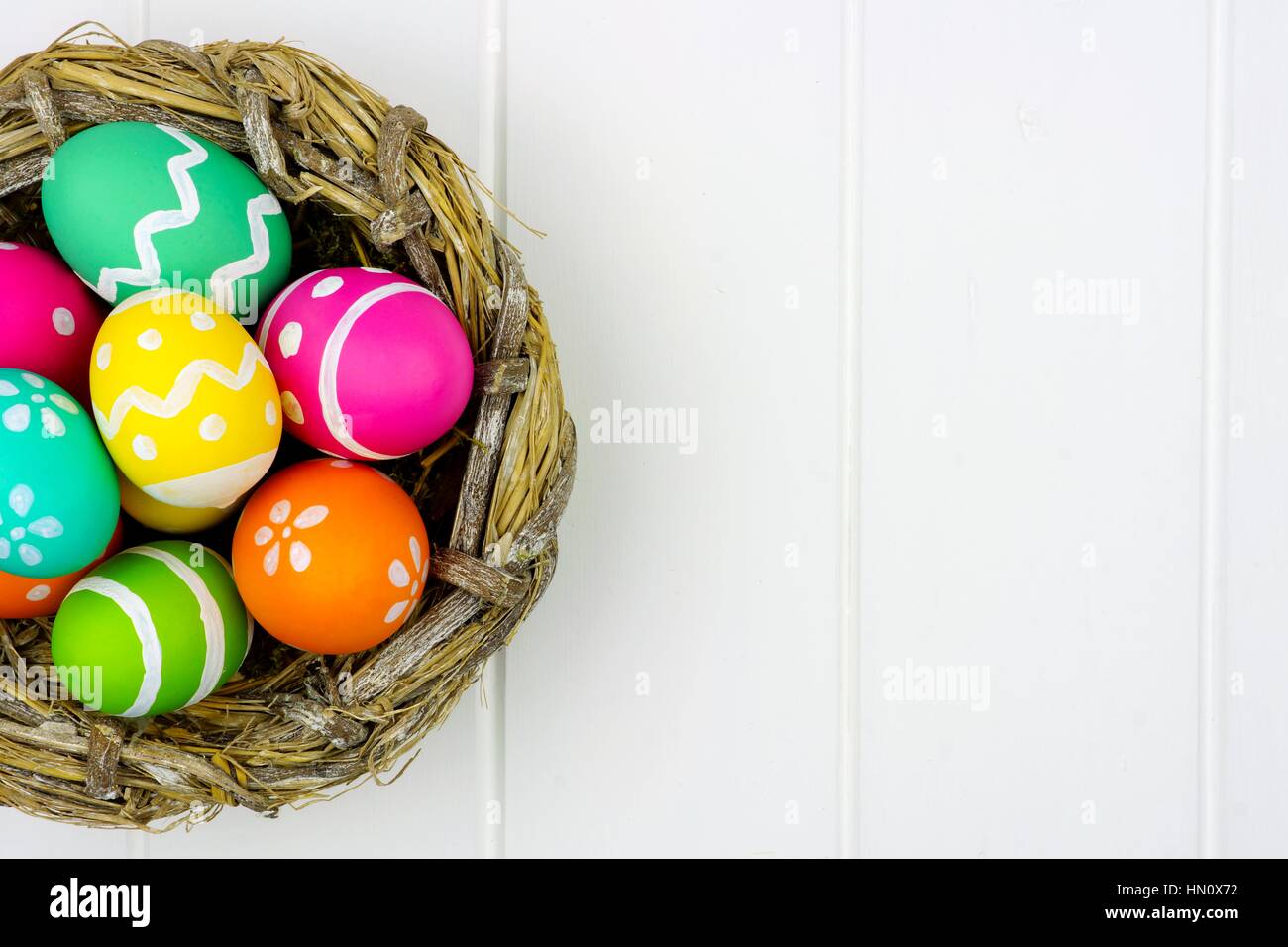 Close up of a spring nest filled with colorful Easter Eggs against a ...