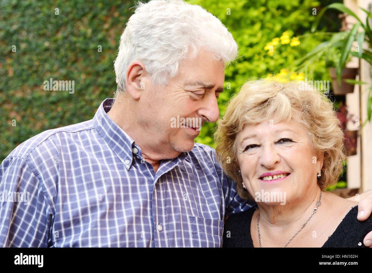 Portrait of an elderly couple sitting outdoors Stock Photo - Alamy