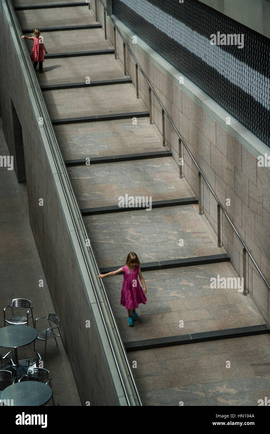 Two young girls descend a slanted staircase in the National Gallery of Canada. Stock Photo