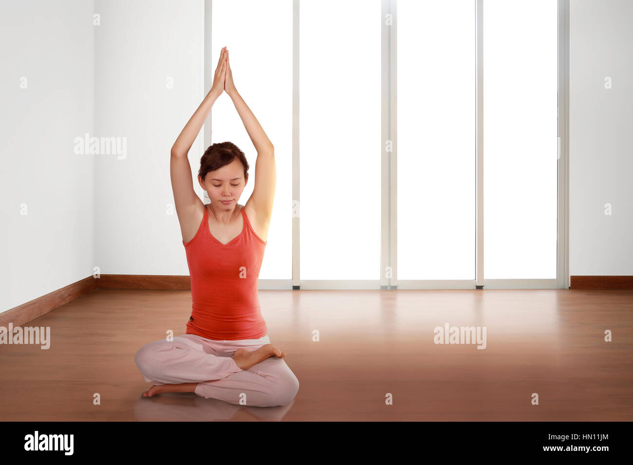 Beautiful asian woman practicing yoga at home Stock Photo - Alamy