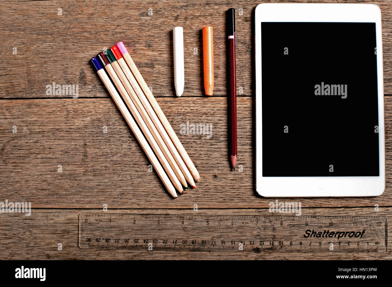 A modern designers tools including a modern tablet set against a wood background with copy space Stock Photo