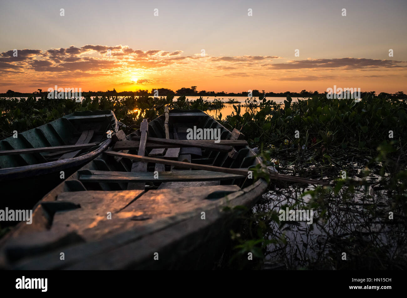 Fishermen's boats in Puerto Pollo at Rio Paraguay in Paraguay's Pantanal at sunset Stock Photo