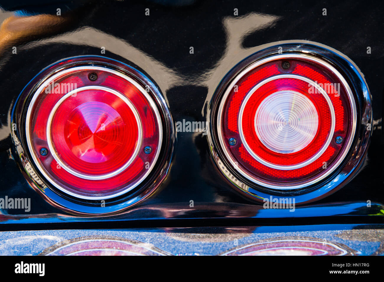 Color and beauty of vintage cars. Red round rear lights of a black ...