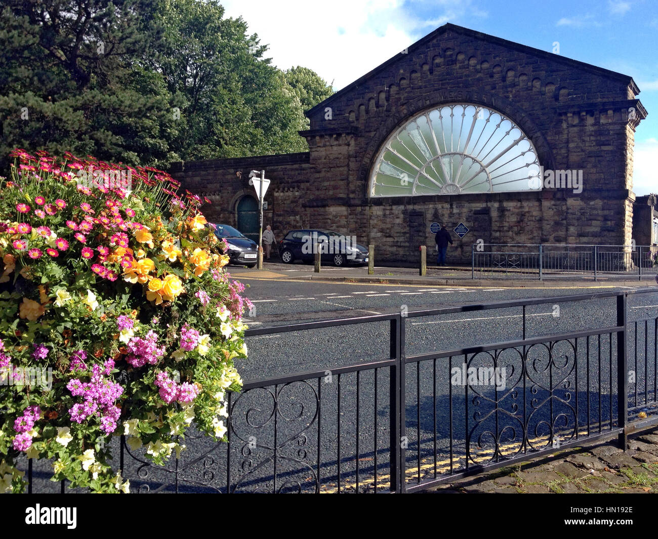 Remaining stone wall with a large fan window of victorian Buxton Station, Buxton, Derbyshire, England, UK Stock Photo