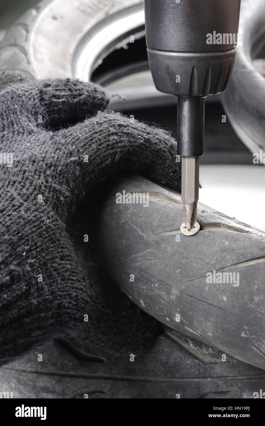 screw nail puncturing motorcycle tire Stock Photo Alamy