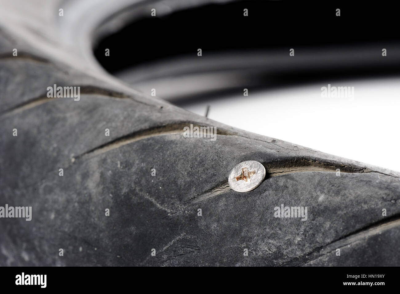 screw nail puncturing motorcycle tire Stock Photo Alamy