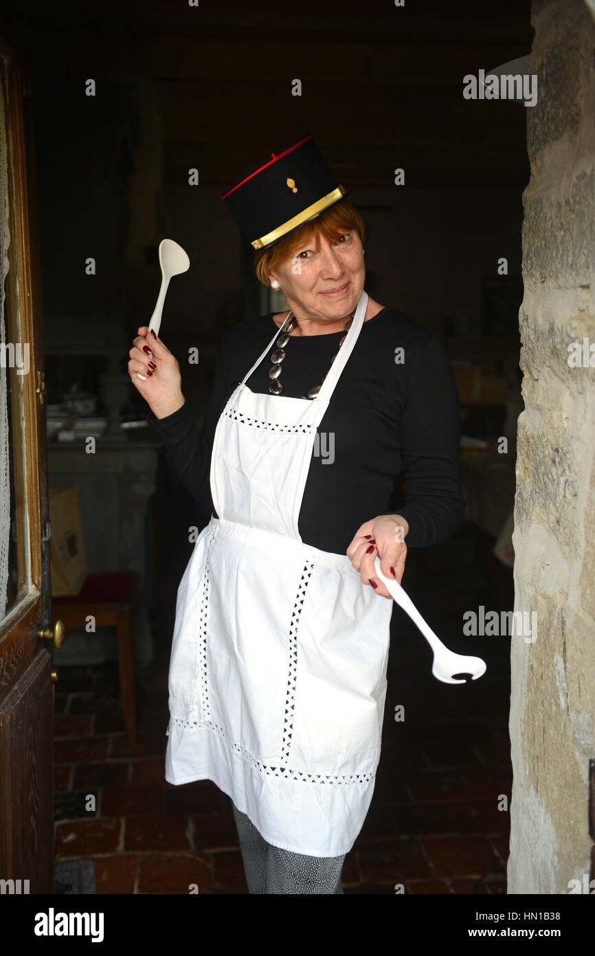 French style cheeky woman cook chef wearing apron Stock Photo