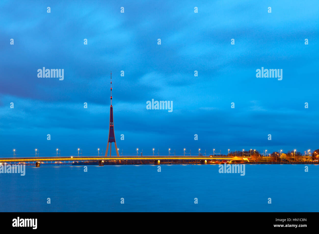 View of Riga TV tower and bridge illumunated at night, Latvia Stock Photo