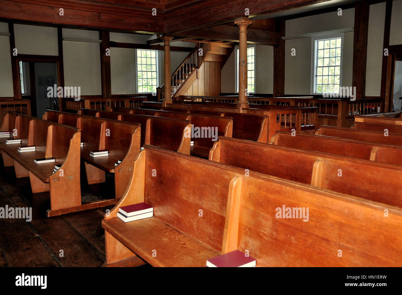 West Barnstable, Massachusetts - July 13, 2015:  Wooden pews with prayer hymnals inside the historic 1717 West Barnstable Parish Meeting House Stock Photo