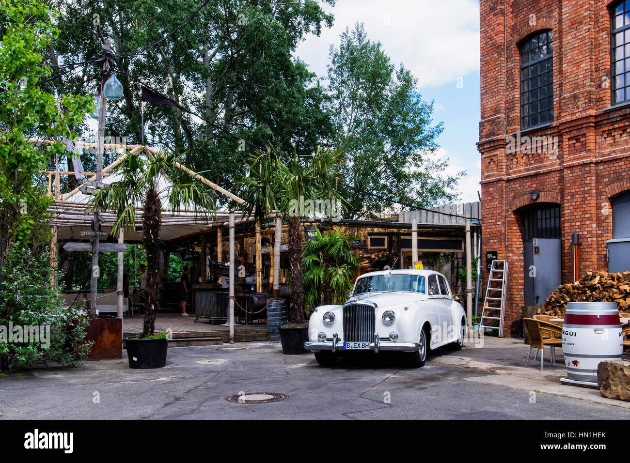 Berlin, Kreuzberg. Sage restaurant housed in a beautifully restored old  building with a Beach Bar next to Spree river.with classic white Rolls  Royce Stock Photo - Alamy