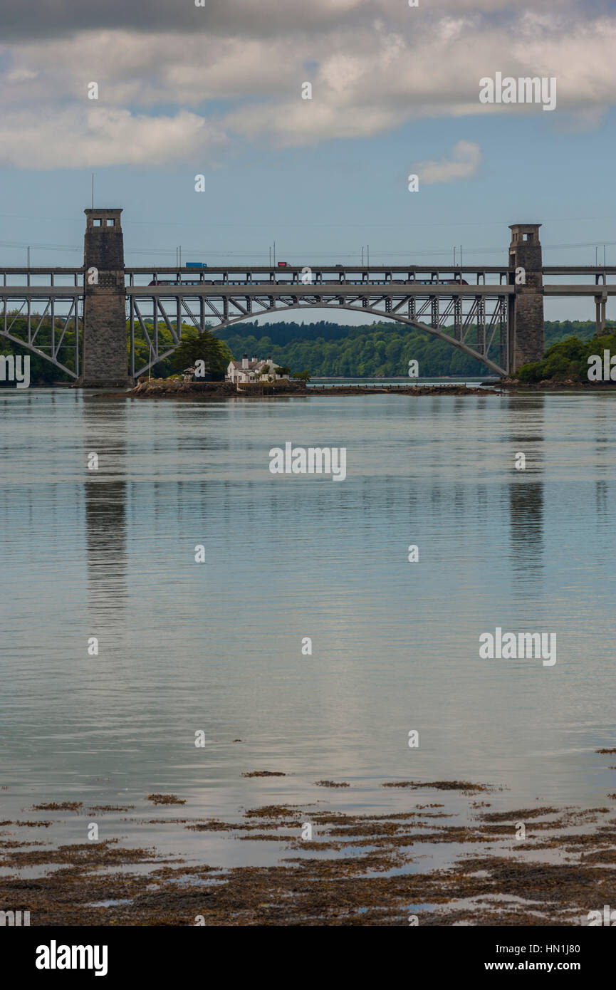 Train crossing The Britannia Bridge (Welsh: Pont Britannia) across the Menai Strait between the island of Anglesey and the mainland of Wales. Stock Photo