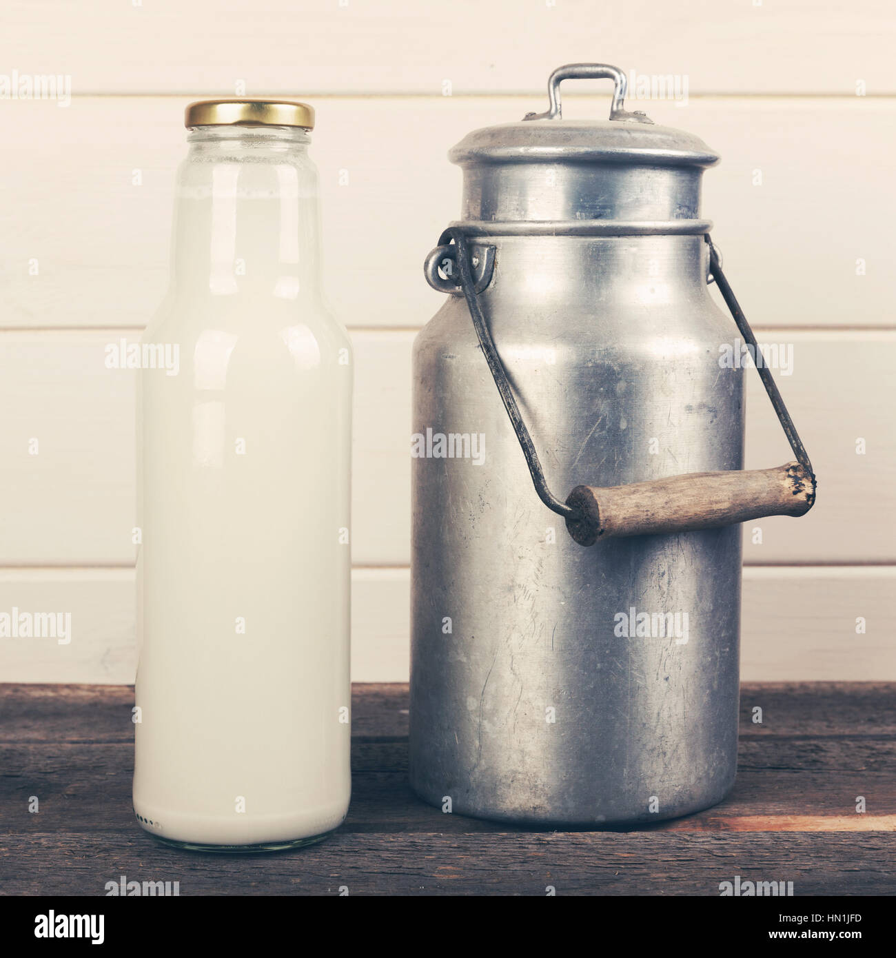 milk bottle and old aluminum can Stock Photo