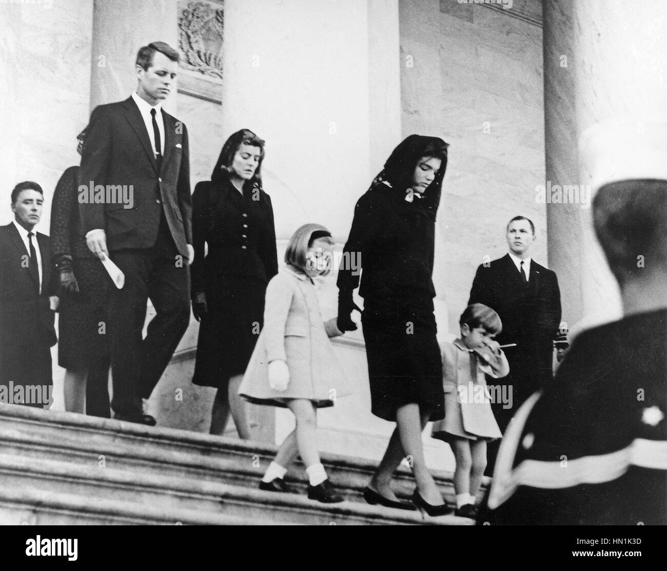 JOHN F. KENNEDY FUNERAL  The family  leaving his funeral service at the Capitol Building in Washington on 25 November 1963. From left: Peter Lawford, Bobby Kennedy, Jean Kennedy, Caroline Kennedy, Jacqueline and John Kennedy Jnr. Photo: Abbie Row/White House Stock Photo
