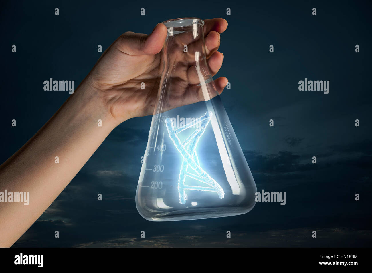 Hand holding glass test tube with DNA molecule inside Stock Photo - Alamy