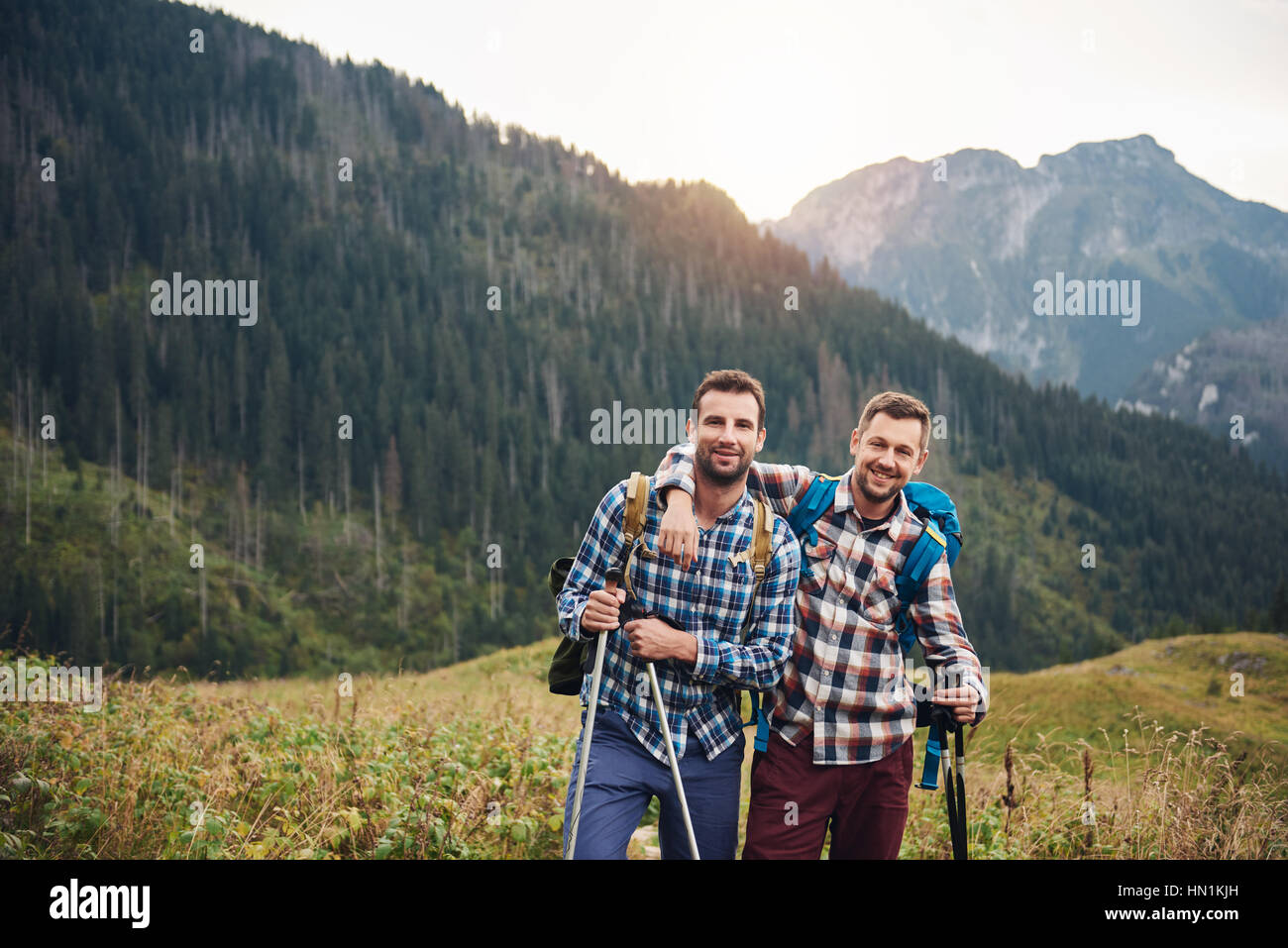 Two friends trekking together in the mountains Stock Photo