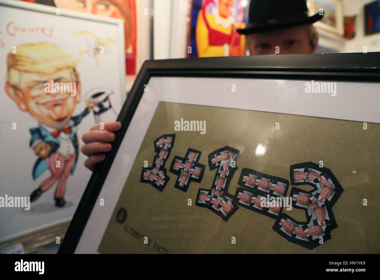 Artist Frank O'Dea holds a framed print of his new work Alternative Facts at his gallery in Dublin's city centre. Stock Photo