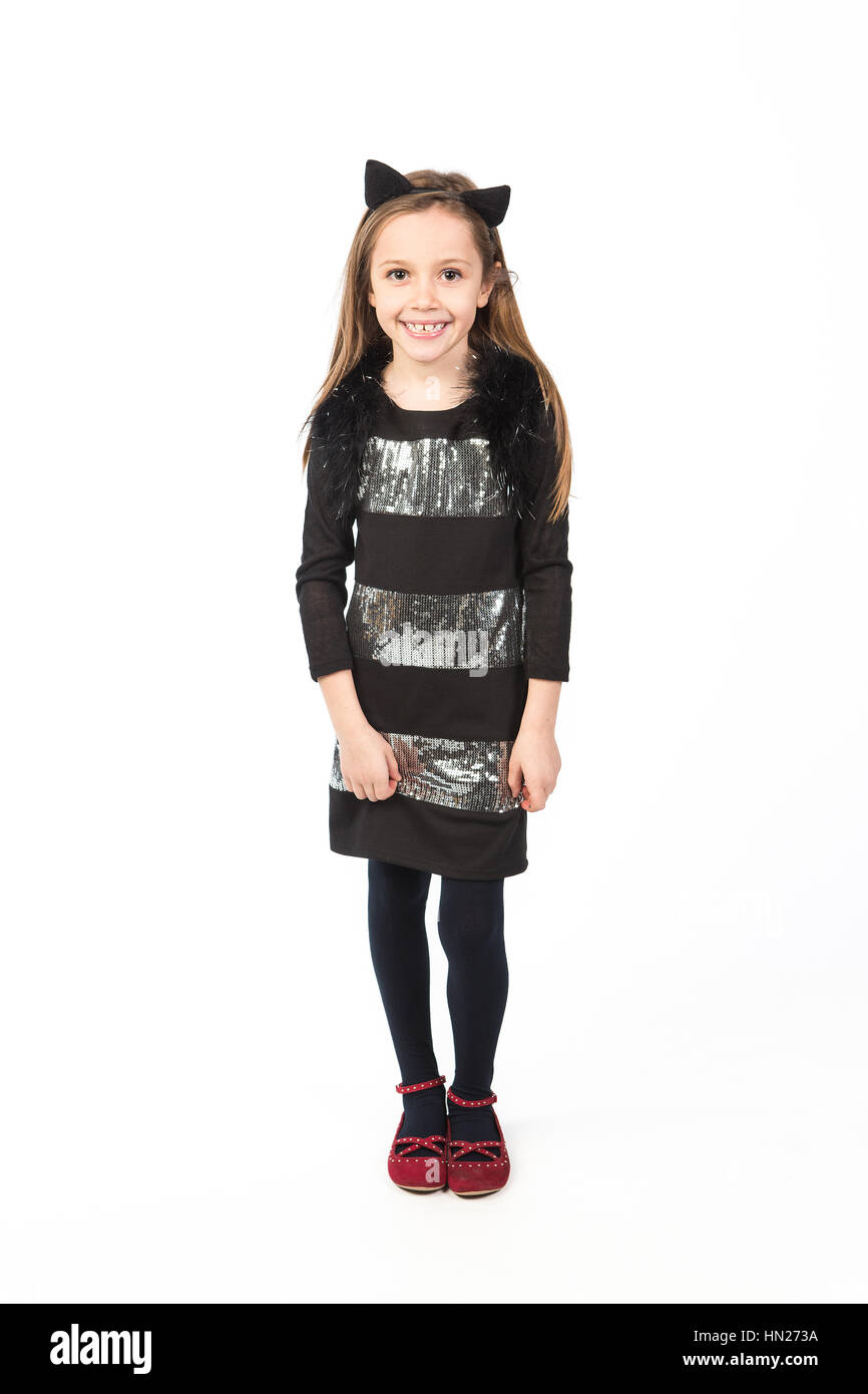 Beautiful little girl dressed as a cat on a white background. Halloween ...