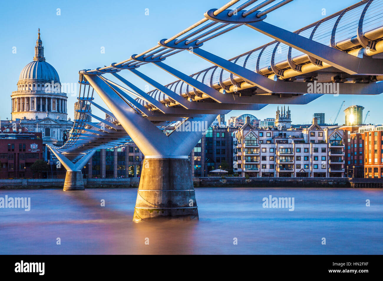 Evening light falls on the Millennium Bridge and St. Paul's Cathedral in London. Stock Photo