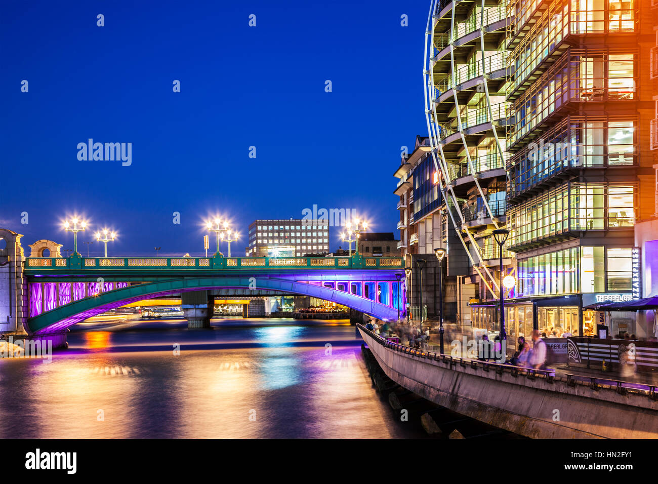 Part of Southwark Bridge and Bankside along the river Thames in London at night. Stock Photo
