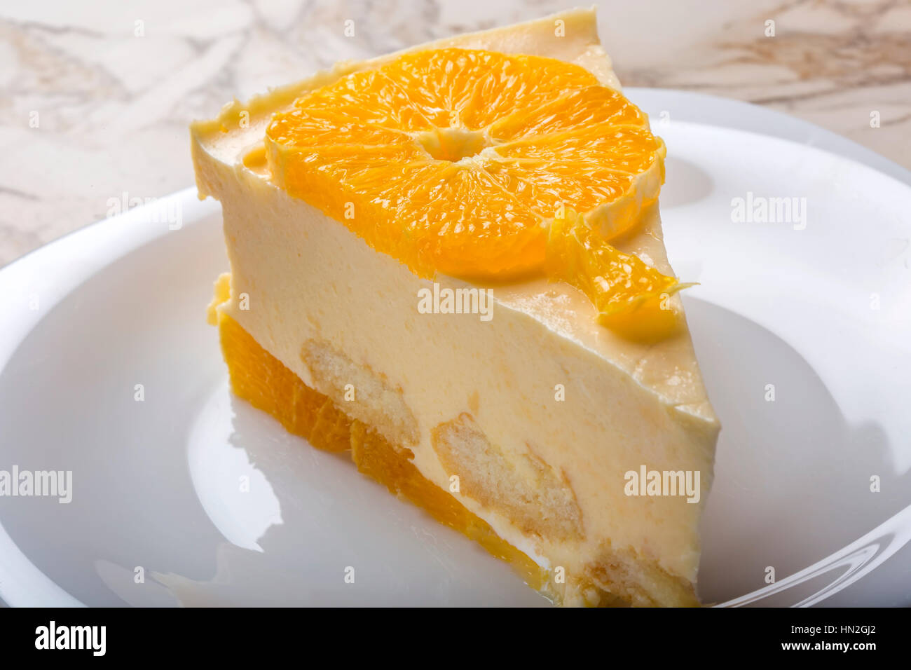 Close up of one slice of homemade orange cake on plate Stock Photo