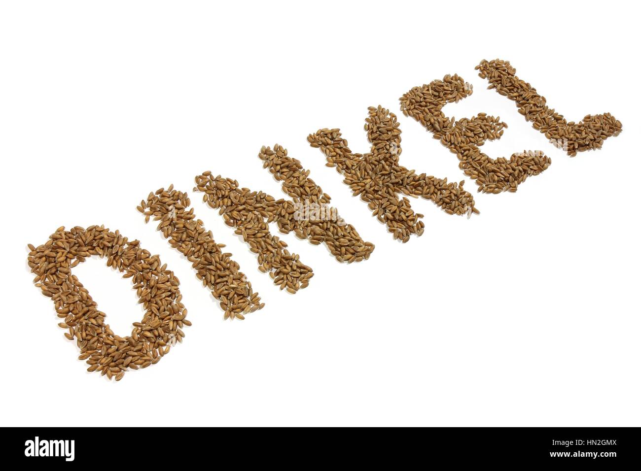 DINKEL (spelt in German language) written with spelt grains isolated on white background Stock Photo