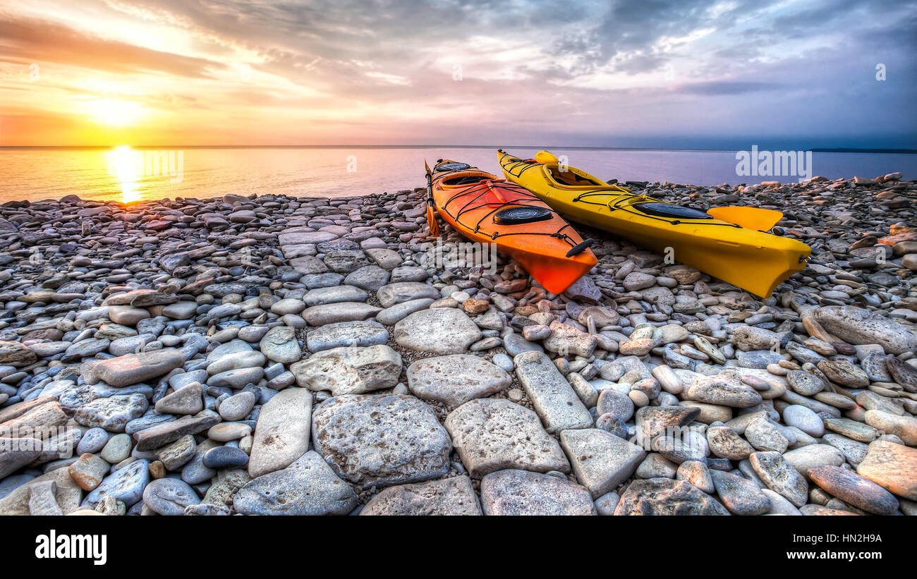 2 kayaks on a rocky beach Stock Photo