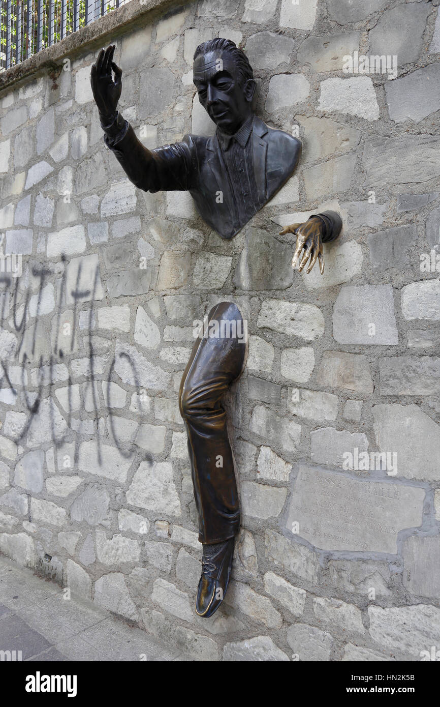 Le Passe-Muraille is the title of a story by Marcel Aymé about a man named Dutilleul who discovers that he can walk through walls, Montmartre Paris, France - shot August, 2015 Stock Photo