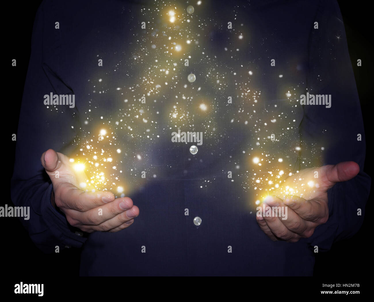 magic sparkles in hands Stock Photo