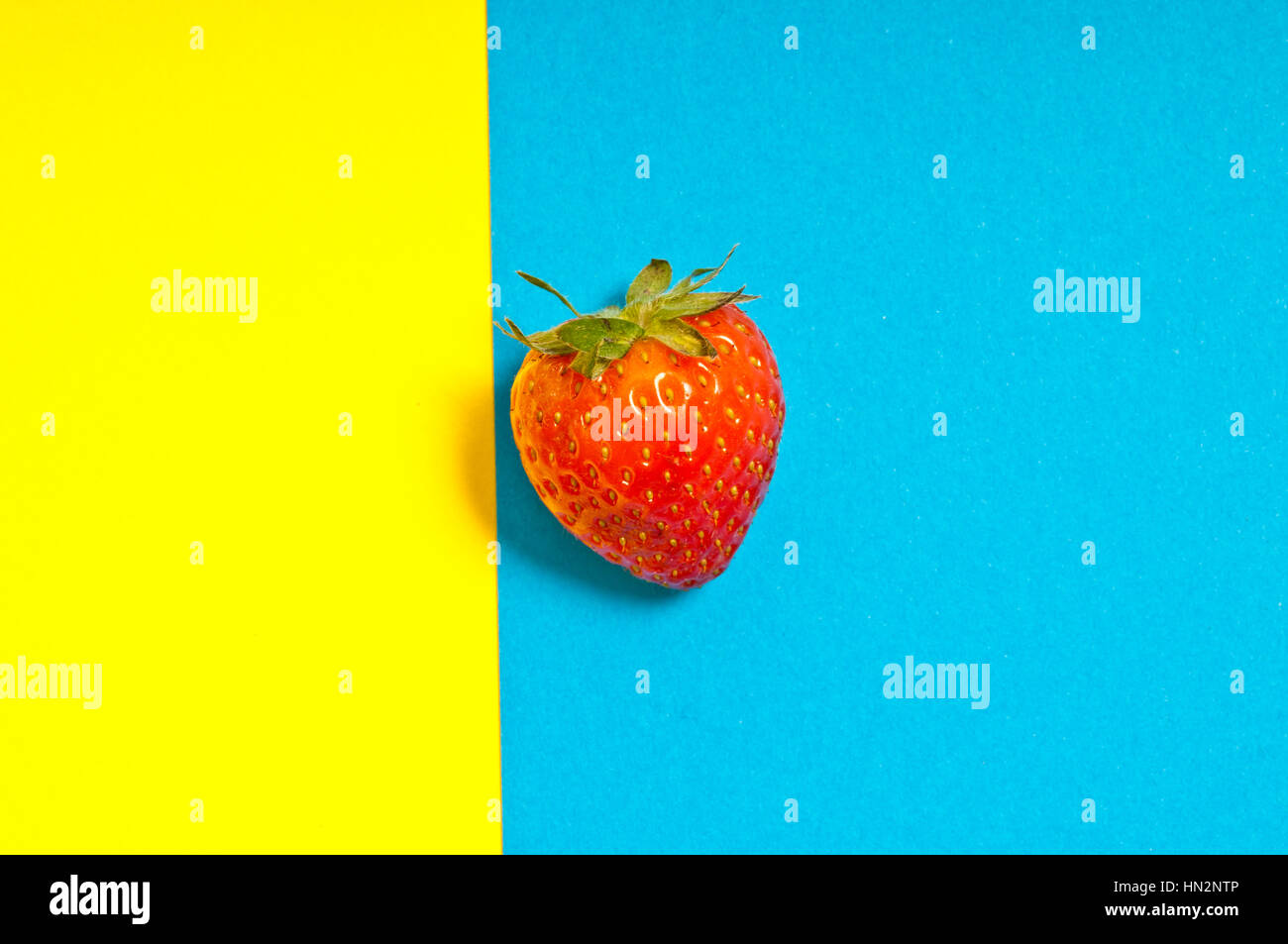 strawberry on a background yellow and blue Stock Photo