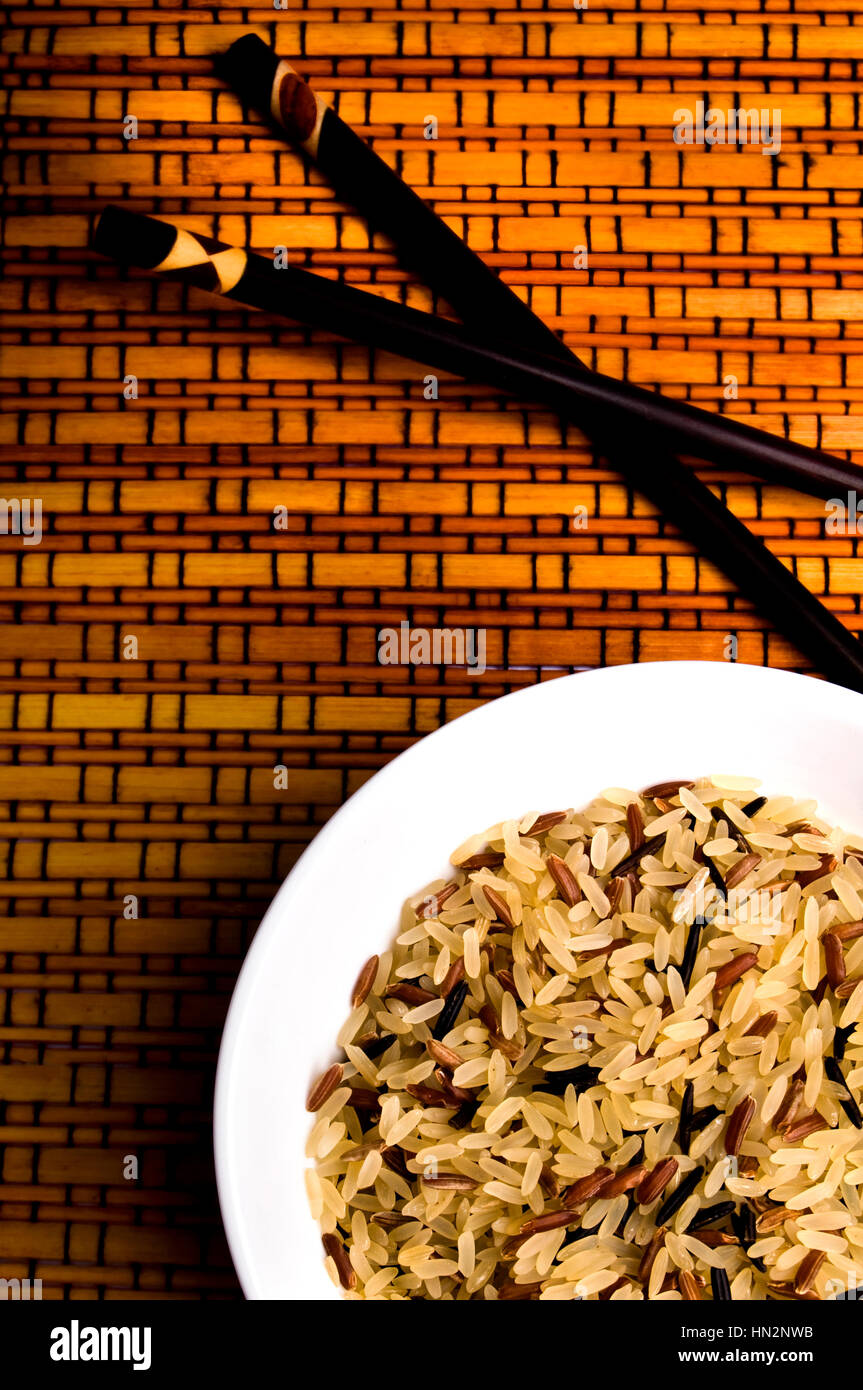 various kind of rice in a bowl, uncooked, and Chinese sticks Stock Photo