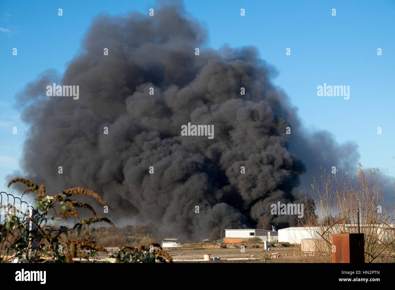 Large factory fire with plumes of thick black smoke Stock Photo - Alamy