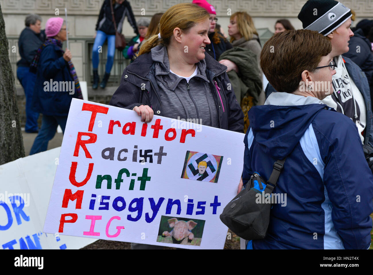 Woman in the demonstration at the Women's March on Washington, DC, holding sign reading 'Traitor, Racist, Unfit, Misogynist, Pig spells TRUMP Stock Photo