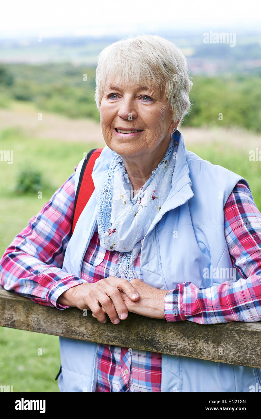 Senior Woman Hiking In Countryside Stock Photo