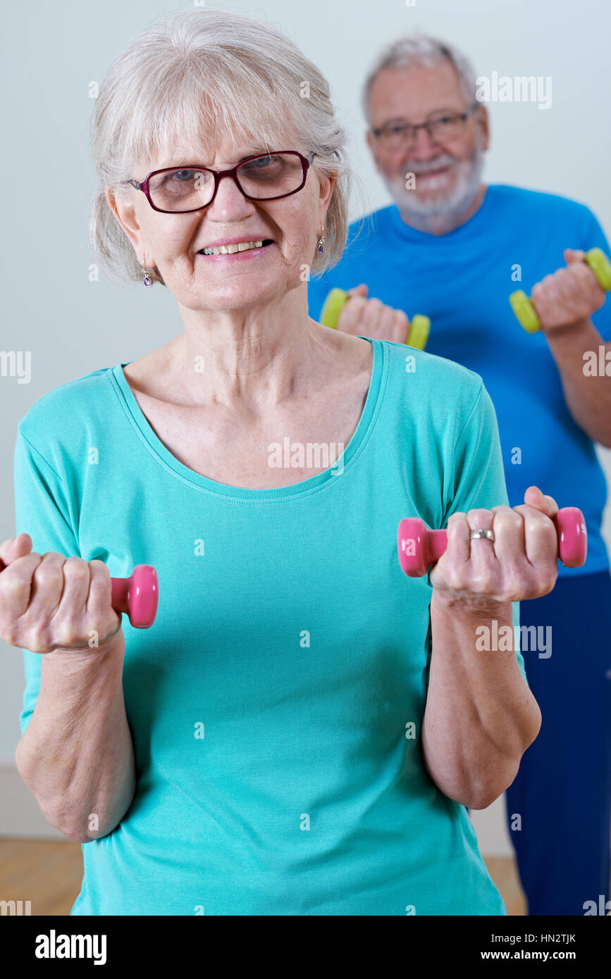 Senior Couple In Fitness Class Using Weights Stock Photo